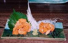 Photo of two sea urchins on flat serving plate