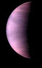 a half Venus is shown, tinted red and purple