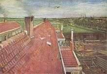 A view from a window of pale red rooftops. A bird flying in the blue sky and in the near distance fields and to the right, the town and others buildings can be seen. In the distant horizon are smokestacks