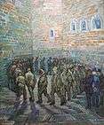 A group of male prisoners (or inmates), walk around and around in a circle, in an indoor prison (or hospital) yard. The high walls and the floor are made of stone. In the right foreground the men are being watched by a small group of three, two men in civilian clothes with top hats and a policeman in uniform. One of the prisoners in the circle looks out towards the viewer, and he has the face of a beardless Vincent van Gogh.