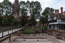 A concrete garden area incorporating ancient ruins