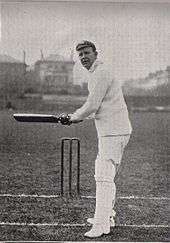 A cricketer preparing to hit the ball.