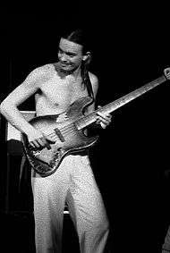 Pastorius, shirtless, playing bass in his early years.