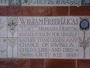 A tablet formed of five tiles of varying sizes, bordered by yellow and blue flowers in an art nouveau style