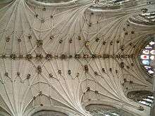 This view shows a vaulted ceiling of great complexity with many small interconnecting ribs. There are carved and gilt stone bosses wherever the ribs meet.