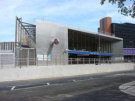 metal and glass building with open front on Wood Lane