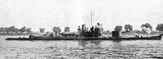 a black and white photograph of a ship on a river