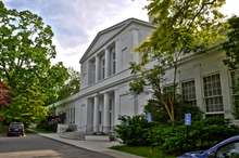 A two-story white Neoclassical school building