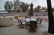 photo of graupel covered lawn furniture in a suburban backyard