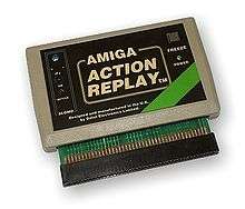 A rectangular software cartridge in a beige case with a black label and connector pins extruding from the bottom.