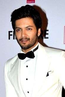 Ali Fazal looking away from camera