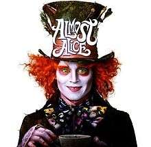 The mad hatter staring directly at the viewer holding up a cup of tea.