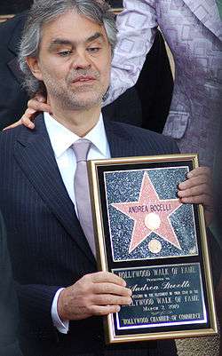 Opera singer Andrea Bocelli holds his plaque with both hands at his 2010 presentation ceremony