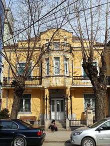 Two-story building on a tree-lined street