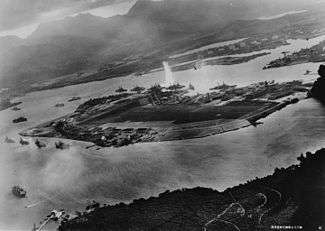 A photograph by an airplane of the Imperial Japanese Navy, facing east over Battleship Row. 7 November 1941.