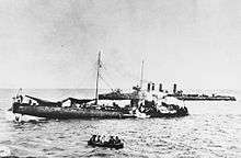 a black and white photograph of a damaged ship