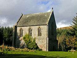 A short, relatively tall chapel, with three arched windows in the near face, and a taller similar window in the face receding to the right