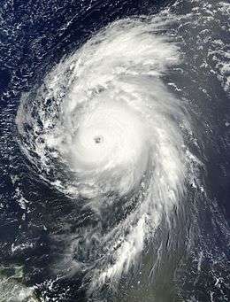 Satellite image of a mature hurricane over the open Atlantic displaying several characteristics of an intense hurricane, including an eye at the center and large spiraling rainbands