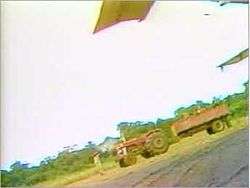 An empty truck sits on an airfield.