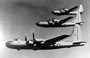 Three large four-engined aircraft in flight