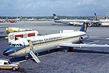 Plane on tarmac, with other planes in the background