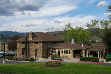 A two-story stone building and parking spaces