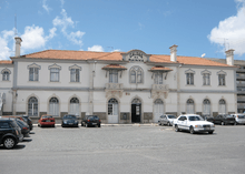 Railway station. Two-story white building with terra-cotta roof. "Caldas da Rainha" written atop center of façade.