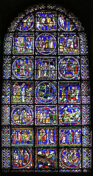 The window has a simple round-arched top. The stained glass is supported by a lead armature of squares and circles which divide it into many separate pictures. The upper pictures show the story of the Three Wise Men. The lower part has an assortment of biblical scenes including "The Sower". The background colour is deep blue.