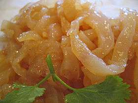 Photo of gold-colored jellyfish strips on plate