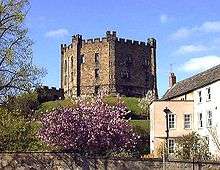 A round castle keep atop a hill