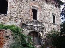 A stone building with a ruined gate