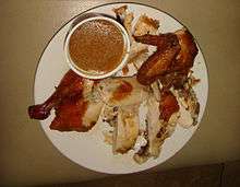 Fried chicken from the Philippines on a plate with dipping sauce.