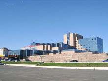 Large, modern building against a clear blue sky