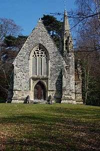 The entrance front of a Gothic chapel with a steep gable and a small spire to the right