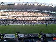 Manchester City fans watch Manchester City play Birmingham City at Eastlands