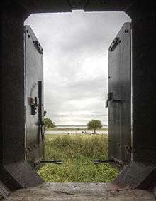 View from within a casemate showing the river, trees and grassy ground