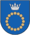 A coat of arms depicting a circle for which the boundary is itself made up of beige circles all under a silver crown on a blue background