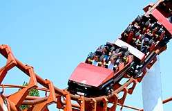 Photograph of a red roller coaster in Vancoucer performing a loop.