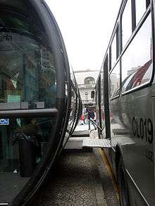 ramps lowered from the side of a bus are level with the station's high platform