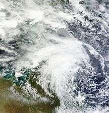 Satellite image of a disorganized cluster of thunderstorms, showing some rotation.