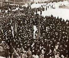 photograph of crowd around flag raising