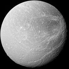 A spherical body is half illuminated from the right. The terminator is running from the top to bottom slightly to the left off the center. The central part of the body is smooth and has only a few craters. A heavily cratered terrain is near the right limb. A part of a large crater is intersected by the terminator in the lower-left corner. To the left of it there is a long crack running parallel to the terminator.