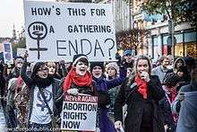 Women carrying placards saying "Abortion Rights Now"