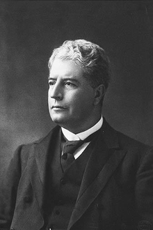 Black and white head and shoulders photograph of well-dressed man