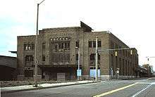 Large, rectangular building with several broken windows