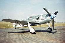 Photo of WWII fighter plane parked on concrete