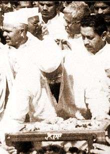 Group of men behind a small table