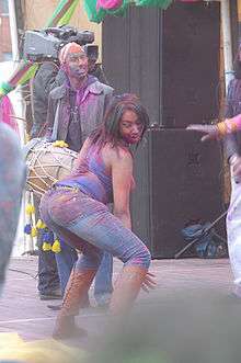 A woman twerking at a music festival.