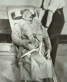 Photograph of the corpse of Glyndwr Michael, strapped to a stretcher in Hackney mortuary