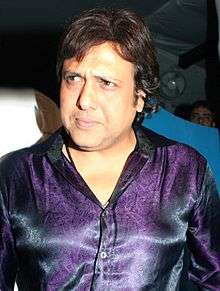 Govinda, looking pensive in a purple satin shirt